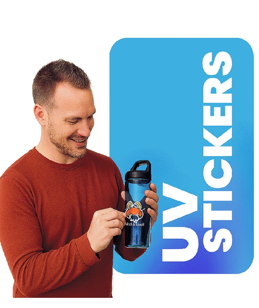 Man applying a custom UV DTF sticker to a black water bottle