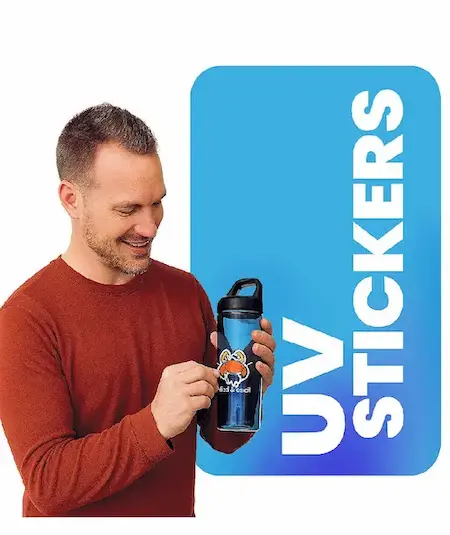Man applying a custom UV DTF sticker to a black water bottle